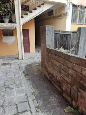 a brick wall in front of a house at Qosqo Apartments 3 in Cusco