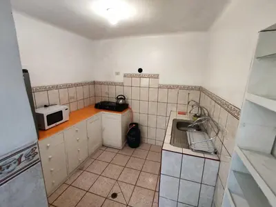 a small kitchen with a sink and a microwave at Qosqo Apartments 3 in Cusco