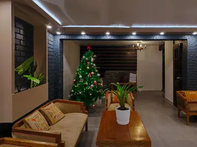 a christmas tree in a living room with a couch at NaturaLodge Machu Picchu in Machu Picchu