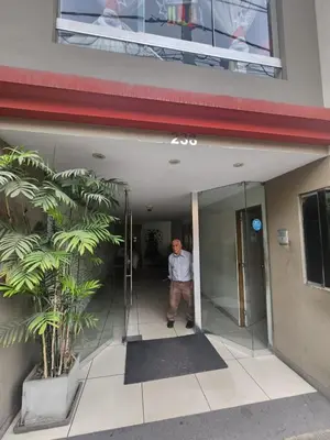 a man standing in the doorway of a building at rodrich business apartment in Lima