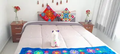 a bedroom with a bed with a stuffed animal on it at Encanta Perú Apartment in Cusco