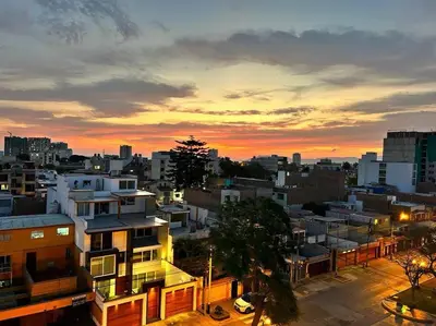 a view of a city at sunset at Departamento de Estreno - cerca a la Playa in Lima