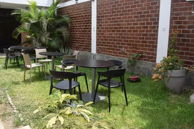 a group of tables and chairs in a yard at El Valle - Lunahuaná in Lunahuaná