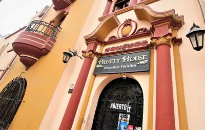 a building with a sign over the entrance to a party house at Pretty House Hotel in Lima