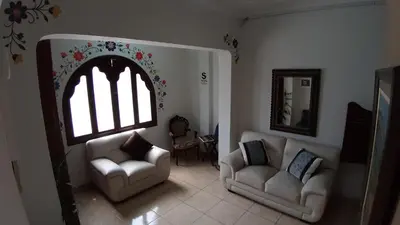 a living room with two chairs and a window at Pretty House Hotel in Lima