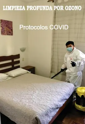 a man vacuum cleaning a bed with a mop at Pretty House Hotel in Lima