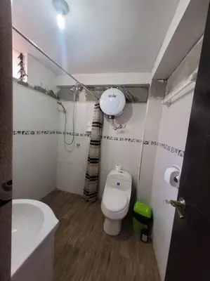 a small bathroom with a toilet and a sink at Apartamento en Huancayo in Huancayo