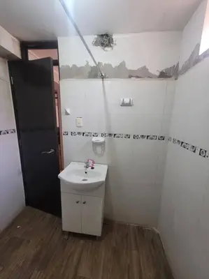 a small bathroom with a sink and a mirror at Apartamento en Huancayo in Huancayo