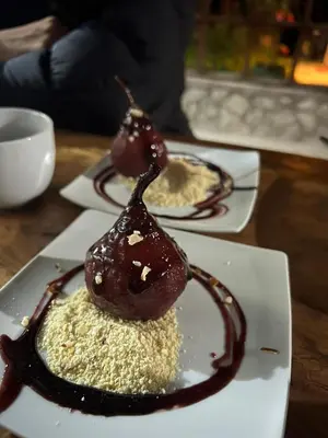 two plates of food on a table with chocolate sauce at Lucmabamba Lodge in Santa Teresa