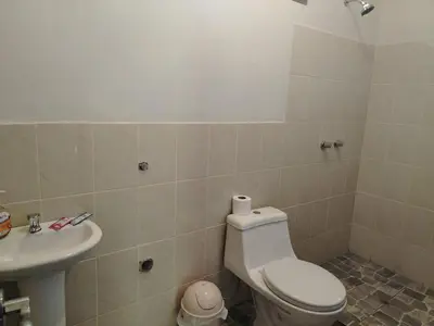 a bathroom with a toilet and a sink at Lucmabamba Lodge in Santa Teresa