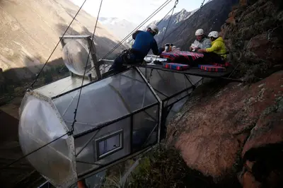 a group of people sitting at a table on a mountain at Skylodge Adventure Suites in Urubamba