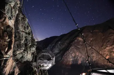 a starry sky over a mountain at night at Skylodge Adventure Suites in Urubamba