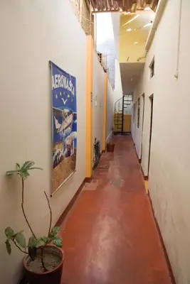 an empty hallway with a potted plant in a building at Brabant Hostal in Nazca
