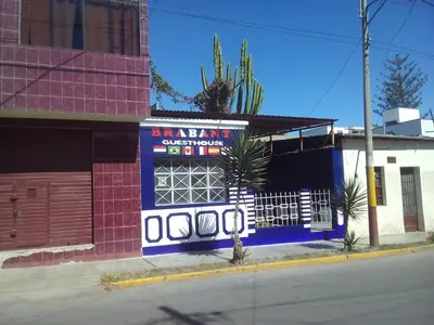 a blue and white building with a sign on it at Brabant Hostal in Nazca