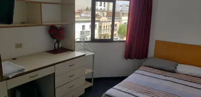 a bedroom with a desk and a bed and a window at Hospedaje Miraflores 17 in Lima