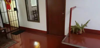 a hallway with a door and a potted plant at Hospedaje Miraflores 17 in Lima
