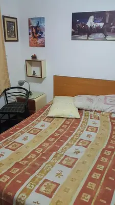 a bedroom with a bed with a bedspread on it at Hospedaje Miraflores 17 in Lima