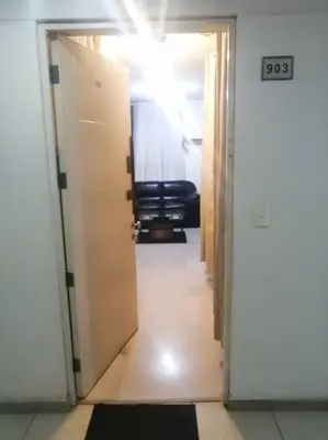 a hallway with a door open to a room at Mini departamento lujo in Lima