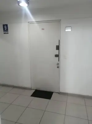 a pair of white doors in a white room at Mini departamento lujo in Lima
