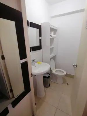 a bathroom with a white toilet and a sink at Mini departamento lujo in Lima