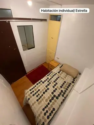a small room with a bed and a mirror at Casa Katya Cusco in Cusco