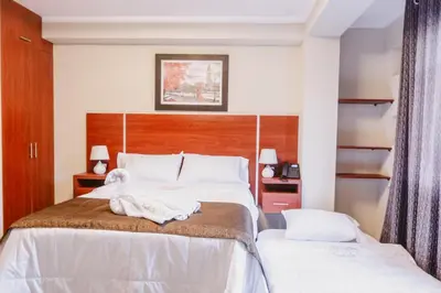 a hotel room with a bed with a towel on it at Hotel Kapadokya in Huánuco