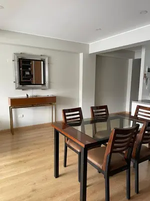 a dining room with a glass table and chairs at Departamento 17 personas San Isidro in Lima