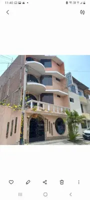 a picture of a building with a sign in front of it at Hostal Luren in Nazca