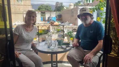 a man and a woman sitting at a table at Hostal Luren in Nazca