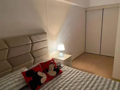 a bedroom with a mickey mouse pillow on a bed at Apartamento en Barranco in Lima