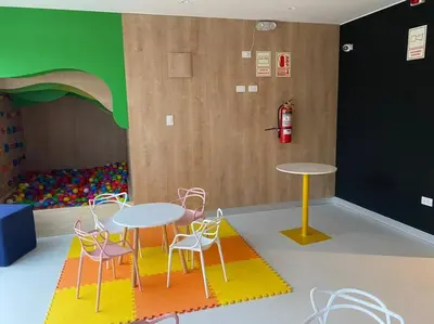 a room with two tables and chairs and a play area at Apartamento en Barranco in Lima