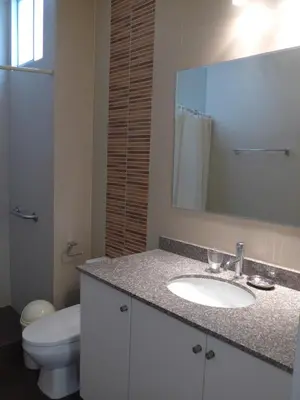 a bathroom with a sink and a toilet and a mirror at Spacious Apartment in Miraflores in Lima