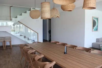 a dining room with a wooden table and chairs at Casa Z Paracas in Paracas