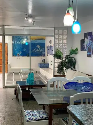 a dining room with a glass table and chairs at Apartamento Playa Arica in Lurín