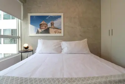 a large white bed in a bedroom with a window at Narciso 350 by Wynwood House in Lima