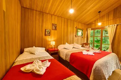 a bedroom with two beds with towels on them at Carolina Egg Gasthaus in Oxapampa