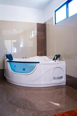 a bath tub sitting in a room with at Casablanca Hotel in San Ramón