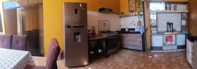 a kitchen with a stainless steel refrigerator in a room at Casa - Hospedaje Munay Ki - Yoga - in Pisco