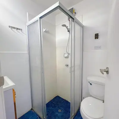 a bathroom with a shower and a toilet at Hostel Prada in Lima