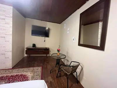 a room with a table and a mirror and a bed at Casa Virgen del Carmen in Cusco