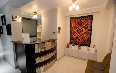 a bar in a room with a tapestry on the wall at Hotel Melthon Urbans in Ayacucho