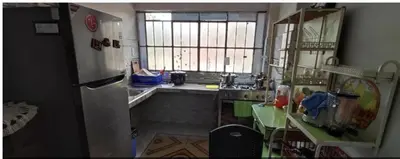 a small kitchen with a sink and a refrigerator at LA POSADA CHASQUI Perú in Lima