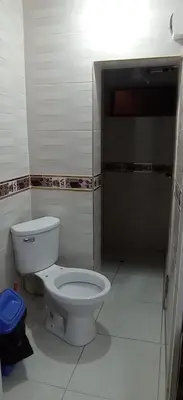 a bathroom with a white toilet in a room at LA POSADA CHASQUI Perú in Lima