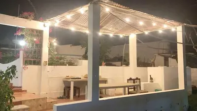 a pavilion with a picnic table and lights on it at Casa de Campo - Fundo Raquel in Ica
