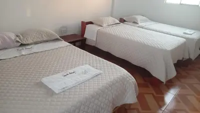 two beds with a towel on top of them at Casa de Campo - Fundo Raquel in Ica