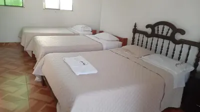 a group of three beds in a room at Casa de Campo - Fundo Raquel in Ica