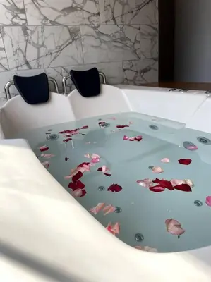 a white bed with a flower pattern on it at Casa Dama in Cieneguilla