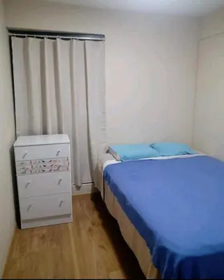 a small bedroom with a bed and a dresser at Habitación Cama 2 plazas persona sola p pareja in Lima