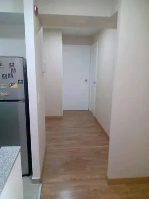 an empty kitchen with a refrigerator and a hallway at Habitación Cama 2 plazas persona sola p pareja in Lima