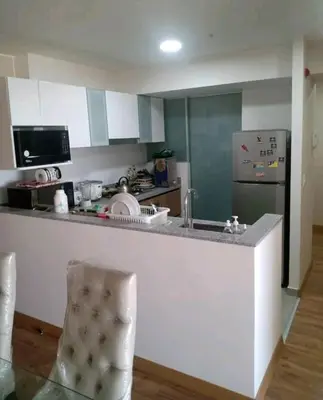 a kitchen with a counter and a refrigerator at Habitación Cama 2 plazas persona sola p pareja in Lima